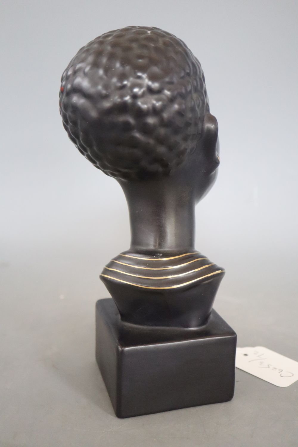 A 1960s ceramic bust of a tribal woman, signed, height 22cm